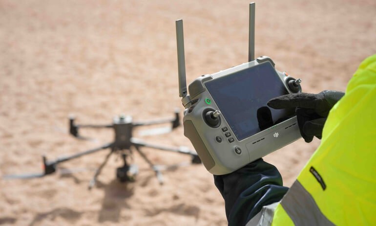AeroIQ operator with a DJI Matrice and RC Plus controller in the field