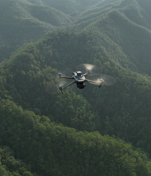 Enterprise drone flying over forest for remote monitoring, environmental assessment and forestry management in New Zealand